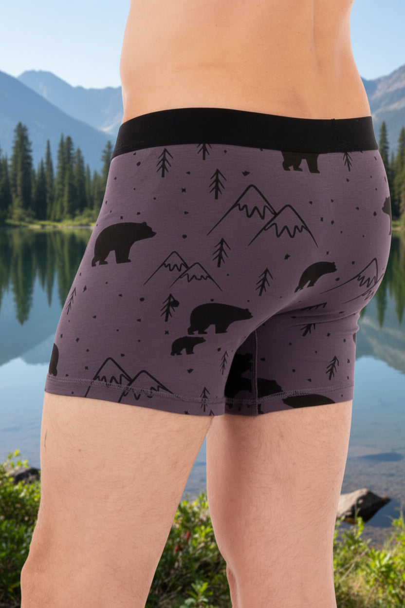 This image displays a pair of men's boxer briefs, labeled as the "65_WABU_Boxer Greystone Bear". The boxers are presented in a dark grey color, adorned with a playful pattern featuring bears and mountains.