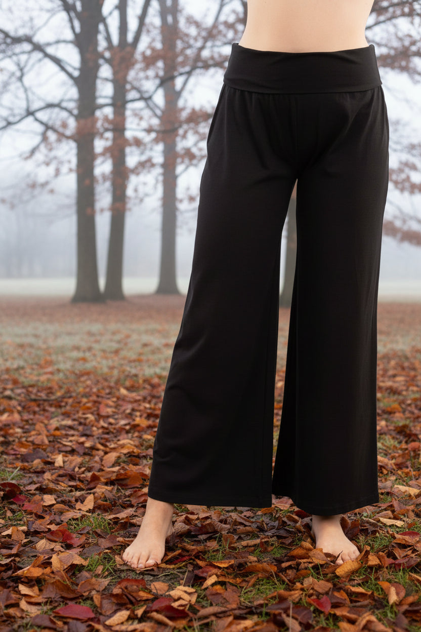 Black wide-leg pants worn by a person on a white background