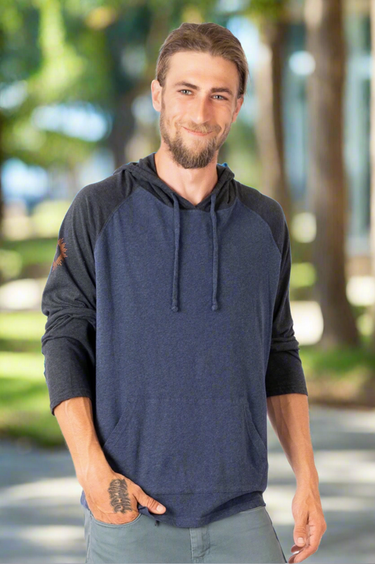 Man wearing a navy blue hoodie with black sleeves on a white background