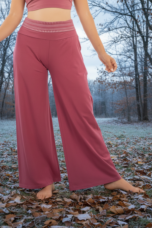 A pair of gray Camala pants with a printed waist, made from organic cotton, modeled against a white background.
