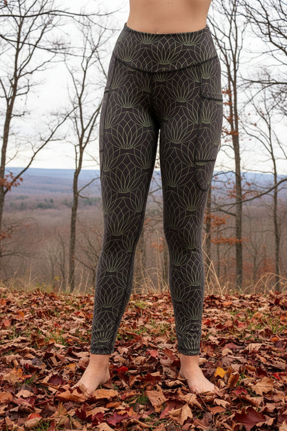 Person wearing gray leggings with a geometric pattern on a white background